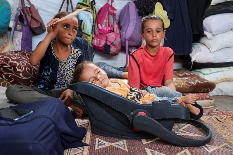 Palestinian boy Abdul Rahman Abu Al-Jidyan, who is the first person to contract polio in Gaza in 25 years, is fanned by his sister at their tent, in Deir Al-Balah, in the central Gaza Strip August 28, 2024. REUTERS/Ramadan Abed