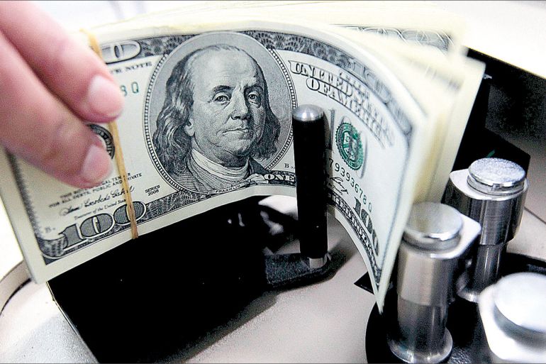 A bank employee counts U.S. hundred dollar bills at Kasikornbank in Bangkok October 12, 2010. The Thai government agreed on Tuesday to impose a 15 percent withholding tax on interest and capital gains earned by foreign investors on Thai bonds, the latest bid by an emerging economy to tame its surging currency. From export-dependent Thailand to fast-growing China and Brazil, governments are moving to rein in their currencies as investors, turning their backs on low interest rates in the developed world, pour money into higher-yielding markets. REUTERS/Sukree Sukplang (THAILAND - Tags: POLITICS BUSINESS)