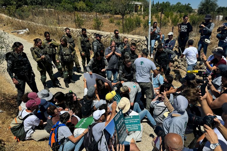 Isreali forces detain activists during a protest against Israeli settlements, near Bethlehem, in the Israel-occupied West Bank August 8, 2024. REUTERS/Yosri Aljamal