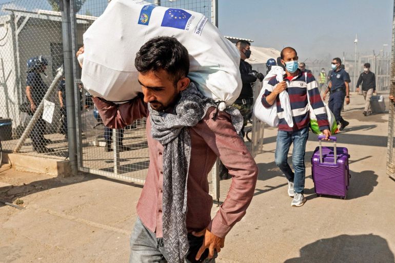 Migrants leave the Pournara camp, the main reception centre for migrants in Cyprus.