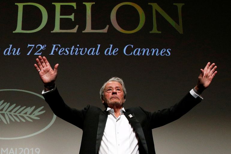 FILE PHOTO: Actor Alain Delon gestures as he receives his honorary Palme d'Or Award. REUTERS/Stephane Mahe/File Photo