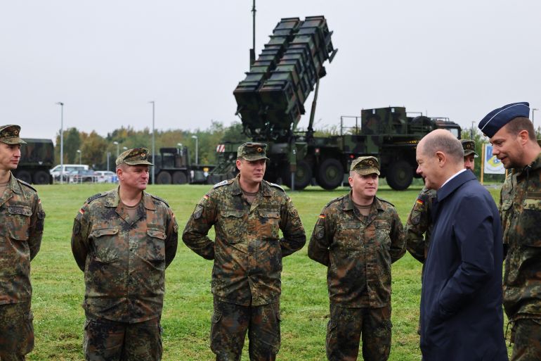 German Chancellor Olaf Scholz meets with members of the Patriot air defense missile system unit as he visits the Cologne-Bonn Air Force base to attend a demonstration of the capabilities of the Territorial Command of the German army Bundeswehr in Wahn, a suburb of Cologne, Germany, October 23, 2023. REUTERS/Wolfgang Rattay