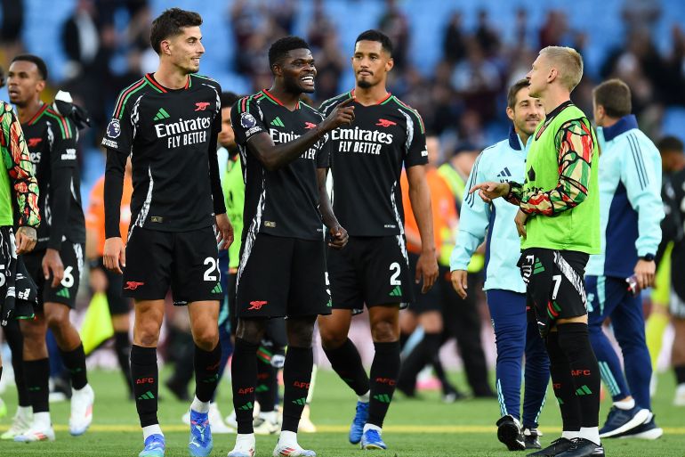 Soccer Football - Premier League - Aston Villa v Arsenal - Villa Park, Birmingham, Britain - August 24, 2024 Arsenal's Thomas Partey, Kai Havertz and William Saliba celebrate after the match REUTERS/Peter Powell EDITORIAL USE ONLY. NO USE WITH UNAUTHORIZED AUDIO, VIDEO, DATA, FIXTURE LISTS, CLUB/LEAGUE LOGOS OR 'LIVE' SERVICES. ONLINE IN-MATCH USE LIMITED TO 120 IMAGES, NO VIDEO EMULATION. NO USE IN BETTING, GAMES OR SINGLE CLUB/LEAGUE/PLAYER PUBLICATIONS. PLEASE CONTACT YOUR ACCOUNT REPRESENTATIVE FOR FURTHER DETAILS..