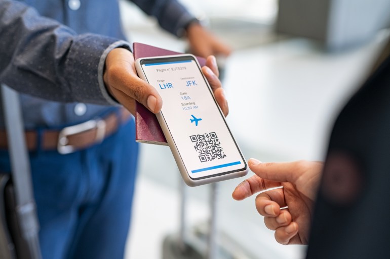 Close up hand of man showing electronic boarding pass