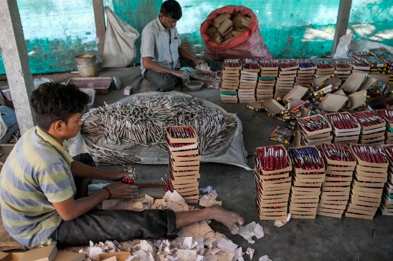 Indian workers make firecrackers for the upcoming Hindu festival Diwali at a factory on the outskirts of Ahmedabad, India, Sunday, Oct. 16, 2022. Fire crackers are in huge demand in India during Diwali, the festival of lights, which will be celebrated on October 24. (AP Photo/Ajit Solanki)