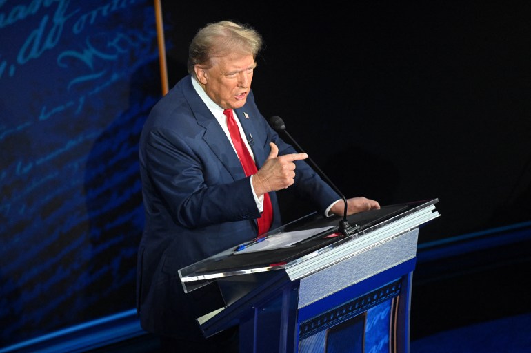 Former US President and Republican presidential candidate Donald Trump speaks as US Vice President and Democratic presidential candidate Kamala Harris listens listens during a presidential debate at the National Constitution Center in Philadelphia, Pennsylvania, on September 10, 2024. (Photo by SAUL LOEB / AFP)