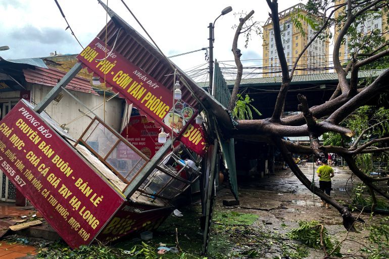 A man walks past a devastated area following the impact of Typhoon Yagi, in Hanoi, Vietnam, September 8, 2024. REUTERS/Thinh Nguyen