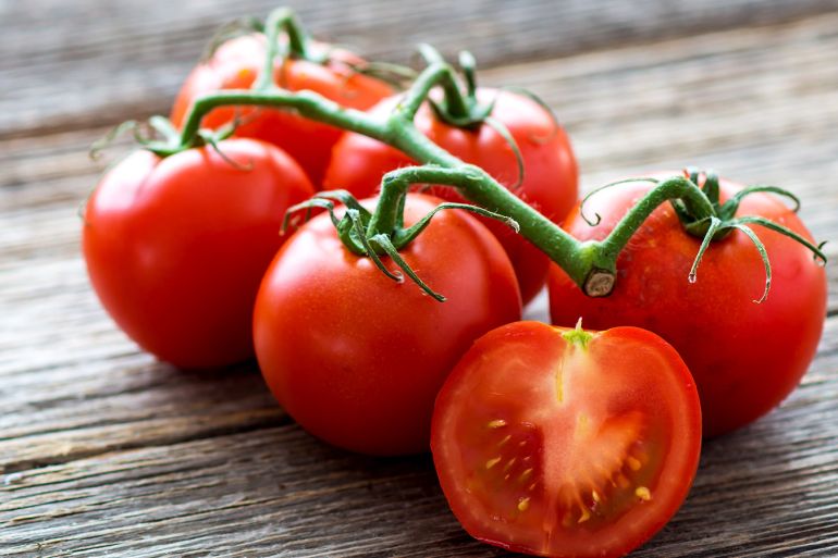 Fresh tomatoes on wood background