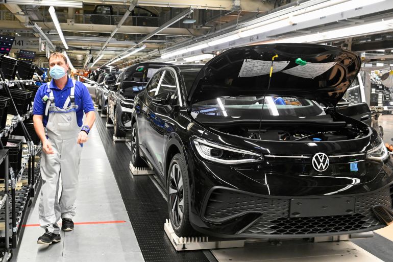 A technical employee works at the production line for the electric Volkswagen model ID.5 car in Zwickau, Germany, January 27, 2022. REUTERS/Matthias Rietschel