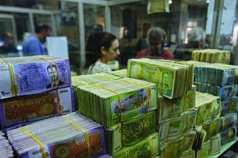 This picture shows stacks of Syrian lira banknotes at the Commercial Bank of Syria in Damascus, on November 10, 2022. (Photo by LOUAI BESHARA / AFP)