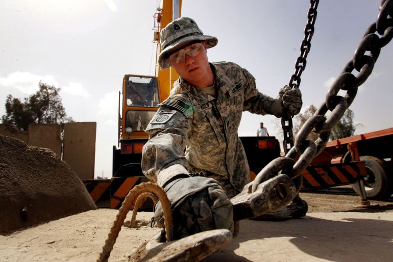 انسحاب أميركي من العراق BAGHDAD, IRAQ - MARCH 10: A U.S. soldier from the 4th Infantry Division removes a concrete block as troops prepare to pull out of Camp Rustamiyah on March 10, 2009 in Baghdad, Iraq. As US President Barack Obama unveiled the details of his plan to withdraw U.S forces from Iraq, violence rose in Baghdad. A suicide bomber struck Shiite and Sunni tribal leaders at a market after they attended a peace conference on March 10, 2009, killing 33 and wounding many more in the town of Abu Ghraib west of Baghdad, Iraq. The attack is the second major attack in just two days. (Photo by Wathiq Khuzaie/Getty Images)