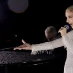 PARIS, FRANCE - JULY 26: (EDITOR'S NOTE: This Handout screengrab was provided by a third-party organization and may not adhere to Getty Images' editorial policy.) This handout released by the Olympic Broadcasting Services, shows a view of singer Celine Dion performing on the Eiffel Tower during the opening ceremony of the Paris 2024 Olympic Games Paris 2024 on July 26, 2024 in Paris, France. (Screengrab by IOC via Getty Images)